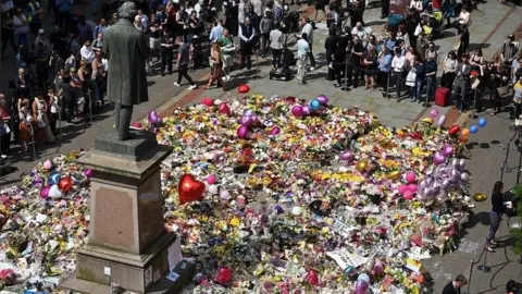 AFP/Getty Images Tributes to Manchester Arena attack victims in St Ann's Square