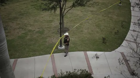 Getty Images A Texas sheriff's deputy guards a university campus during a political event in 2007