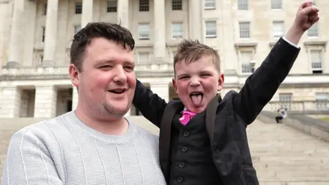 PA Media Daty Mc Gabhan and his father Martin at Parliament House in Stormont