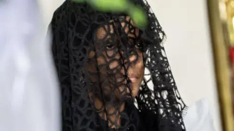 Getty Images Grace Mugabe sit at funeral wake of her husband the late former Zimbabwean president Robert Mugabe on September 12, 2019, at the Blue Roof mansion in Harare