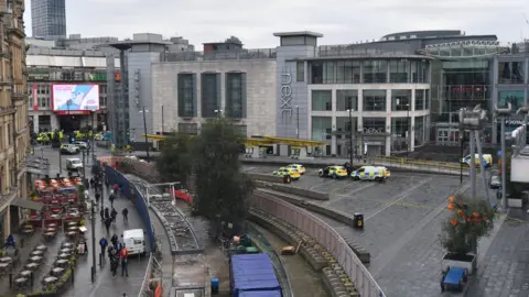 Getty Images View of the Arndale Centre with police cars from a distance