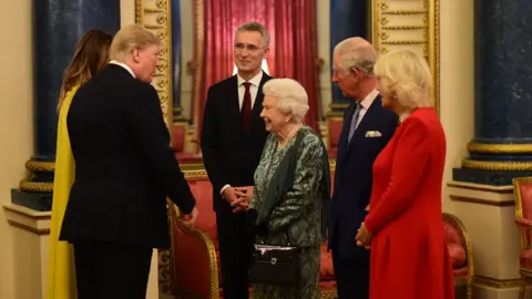 Getty Images The Queen talks to US President Donald Trump and wife Melania as she hosts a reception for Nato leaders at Buckingham Palace