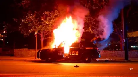CBS/Youtube A police car was set ablaze by protesters at Georgia Tech