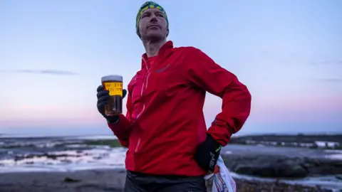 inov-8 / Leo Francis Damian Hall with a pint