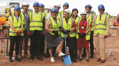 Somerset FT Staff and Rebecca Pow MP cutting the turf before work begins