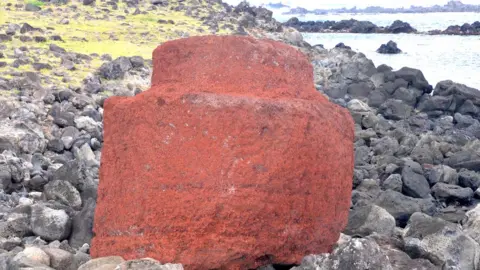 Terry Hunt Red scoria pukoa hat with smaller cylindrical projection on top