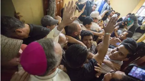 EPA Bishop Silvio Baez (L) calls for calm while a group of government supporters attack several bishops and journalists after violently breaking into the basilica of San Sebastian, in Diriamba, Nicaragua, 09 July 2018.