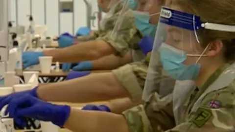 BBC Military personnel carrying out Covid-19 tests