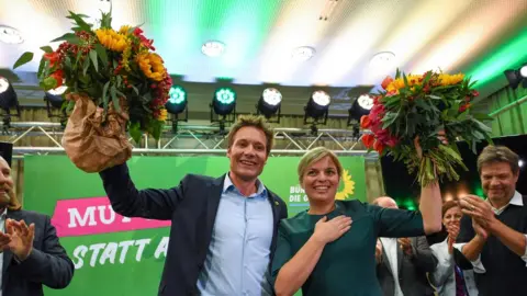 AFP Green leaders Ludwig Hartmann and Katharina Schulze celebrate after hearing exit polls