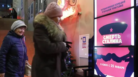 Reuters Russians looking at poster ad for The Death of Stalin, 23 Jan 18