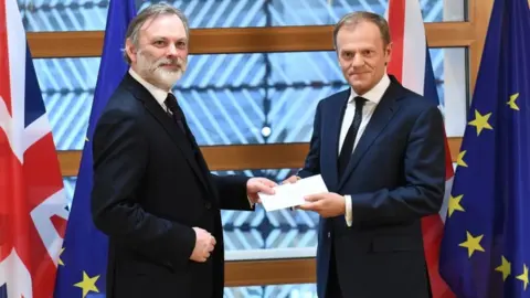 AFP/ Getty Images Tim Barrow and Donald Tusk