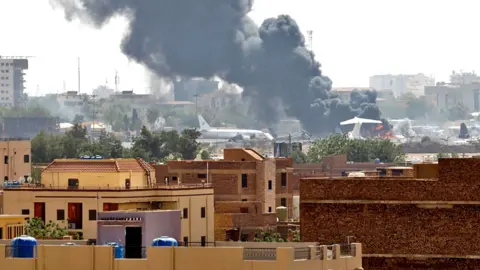 Reuters Smoke rises from burning aircraft inside Khartoum airport during clashes between the paramilitary Rapid Support Forces and the army in Khartoum, Sudan - 17 April 2023