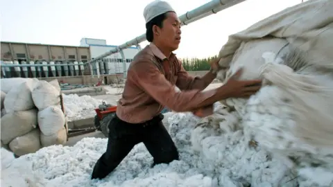 Getty Images The US is to block key exports from China's Xinjiang region due to allegations that they are produced with forced labour,.