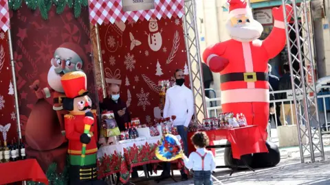 EPA A Christmas market in Manger Square, in Bethlehem, in the occupied West Bank (20 December 2020)