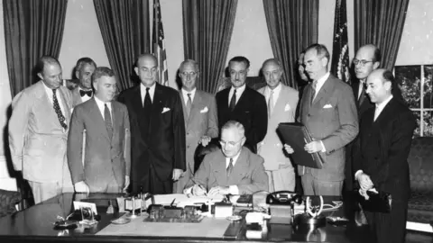 Getty Images President Harry S. Truman signing the North Atlantic Treaty, marking the beginning of NATO, in 1949