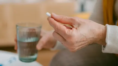 Getty Images hand holding tablet with water