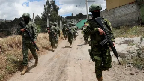 Reuters Soldiers patrol a street prior to Sunday's presidential election, in Quito, Ecuador, August 14, 2023.