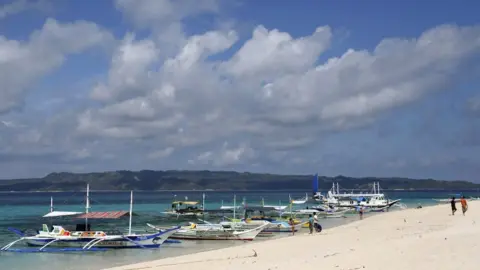 Reuters Traditional boats line up the shore in a secluded beach on the island of Boracay