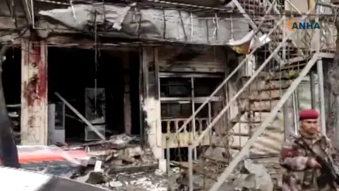 AFP Screengrab of video published by the Syrian Kurdish Hawar News Agency (ANHA) showing the aftermath of a suicide bomb attack in Manbij, Syria (16 January 2019)