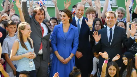 PA The royal couple were greeted with cheers and high fives by children in Berlin