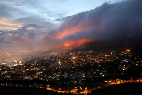 Mike Hutchings / Reuters A fire is seen burning on Table Mountain overlooking Cape Town, South Africa