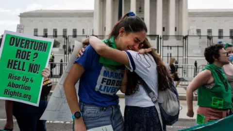 Getty Images Pro-choice demonstrators cry outside the Supreme Court after Roe was overturned