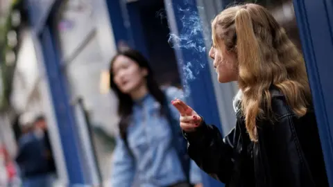 TOLGA AKMEN/EPA-EFE/REX/Shutterstock Young person smoking
