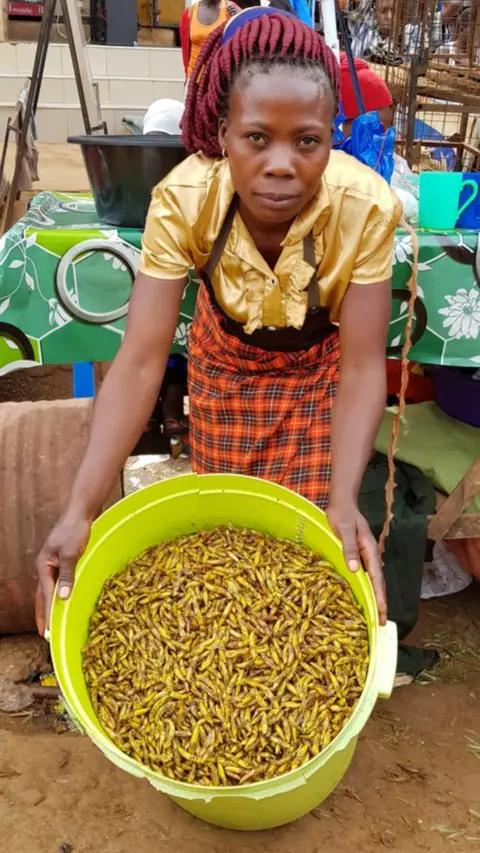 Woman selling grasshoppers