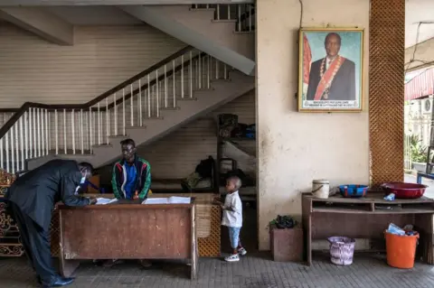 AFP A politician signs in at the Peoples Palace ahead of the first session of talks.
