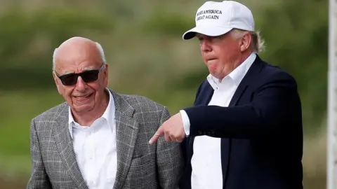 Reuters Donald Trump speaks to Rupert Murdoch (L) at Trump's golf course in Aberdeen, Scotland, in June 2016