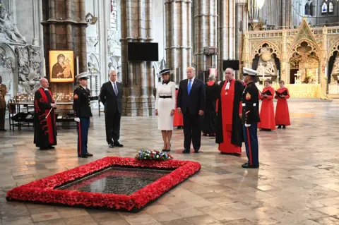 Getty Images US President Donald Trump, accompanied by his wife Melania and Prince Andrew, Duke of York, places a wreath on the grave of the unknown warrior during a visit to Westminster Abbey