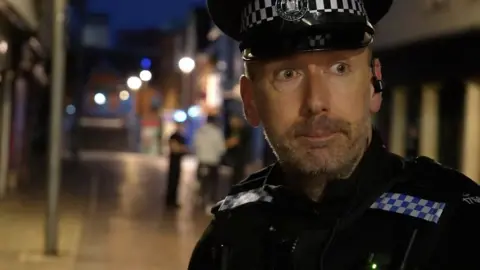 Jamie Niblock/BBC Police officer