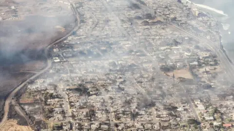 EPA A handout photo made available by Carter Barto shows an arial view of buildings damaged in Lahaina, Hawaii as a result of a large wildfire which has killed 6 people and forced thousands of evacuations on the island of Maui in Hawaii, USA, 09 August 2023. Winds from Hurricane Dora, which is currently over the Pacific Ocean hundreds of miles south of Hawaii, have intensified the wildfires.