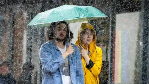 PA Media Couple under umbrella