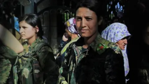 AFP/Getty Images Kurdish female fighter Barin Kobani (right)
