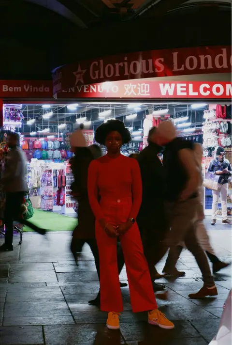 Yumi Codner A woman standing in a busy high street