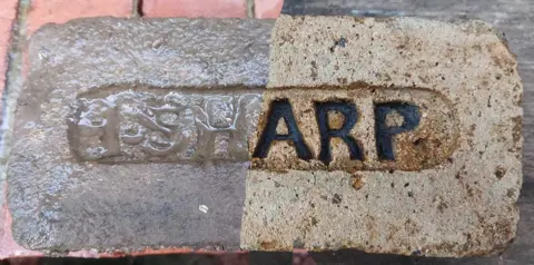 Mike Graham Composite image of a brick, half shown before cleaning and half shown afterwards