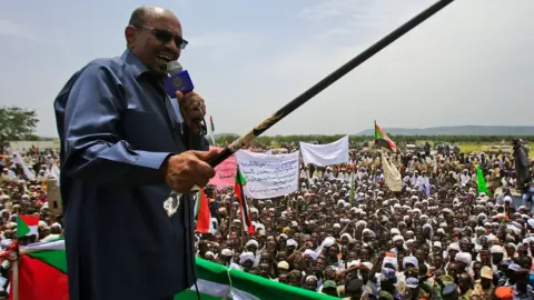 AFP/Getty Images Sudanese President Omar al-Bashir delivers a speech during a visit to the village of Shattaya in South Darfur