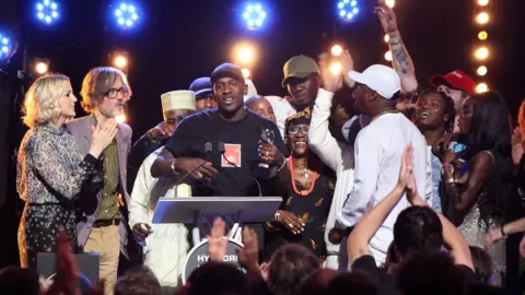 Getty Images Skepta on stage with his friends and family at the Mercury Prize