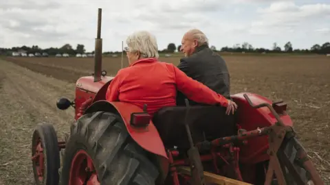 Harry George Hall Catching a lift on a tractor