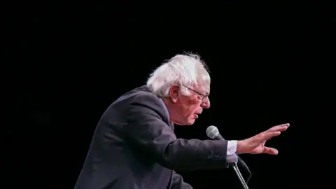 AFP Bernie Sanders speaks into a microphone