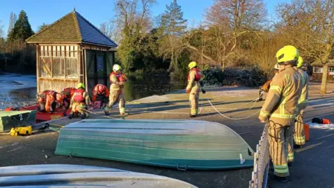 LFB Ponzo is carried by a firefighter across dry ground after a successful rescue