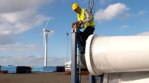 Getty Images worker unloading wind power parts