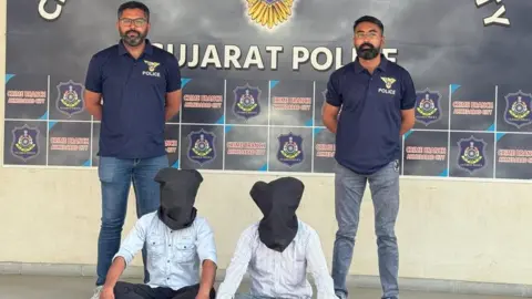 Gujarat Police Police seen with the two arrested persons