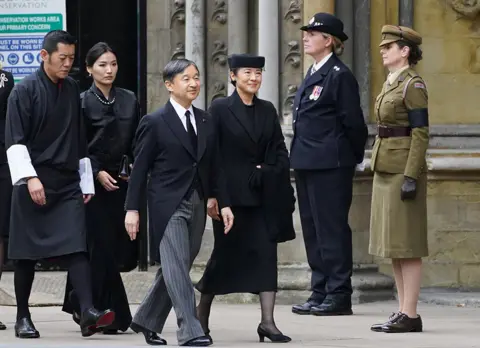 PA Media Emperor of Japan Naruhito (centre) and wife Empress Masako arrive at the State Funeral of Queen Elizabeth II, held at Westminster Abbey, London