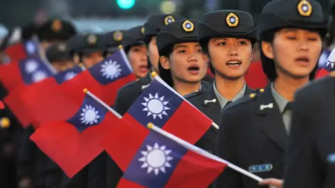 Getty Images Military academy students hold Taiwanese flags in 2013