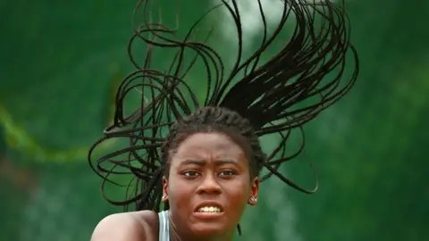 Getty Images Adetayo Adetunji of Nigeria competes in the Girl"s Singles Quarterfinal tennis match between Zeel Desai of India and Adetayo Adetunji of Nigeria on day 4 of the 2017 Youth Commonwealth Games at QE Sports Centre on July 21, 2017 in Nassau, Bahamas.