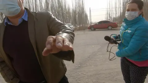 Chinese officials with BBC producer Kathy Long in Xinjiang