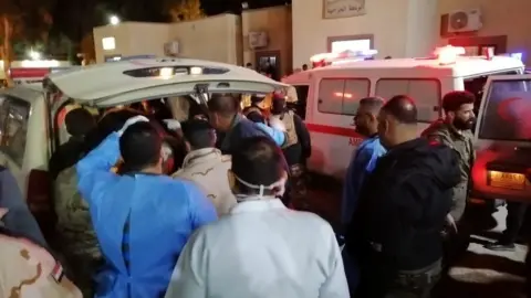 Reuters An ambulance transporting wounded Iraqi paramilitary fighters arrives at a hospital in al-Qaim, Iraq (29 December 2019)