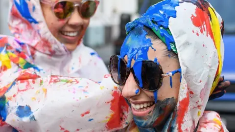 Getty Images Paint-covered revellers take part in the traditional "Jouvert" opening parade